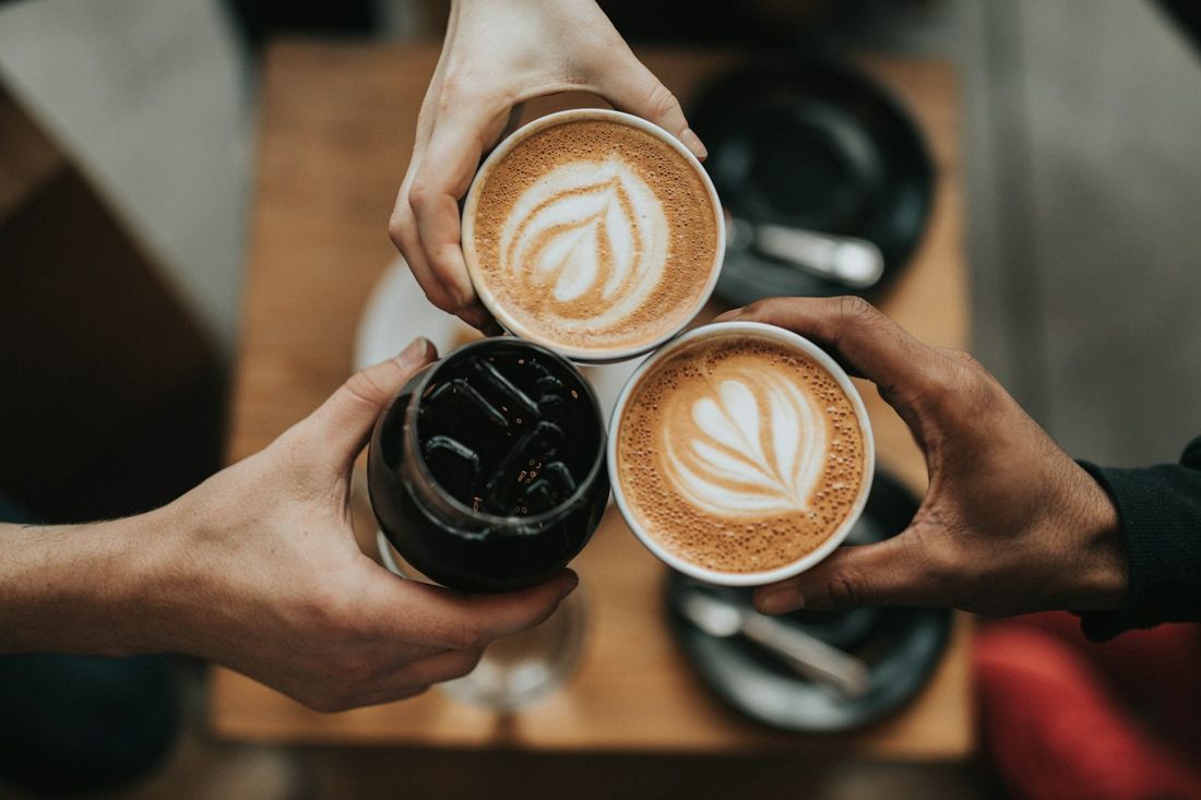 Friends toasting with cups of coffee